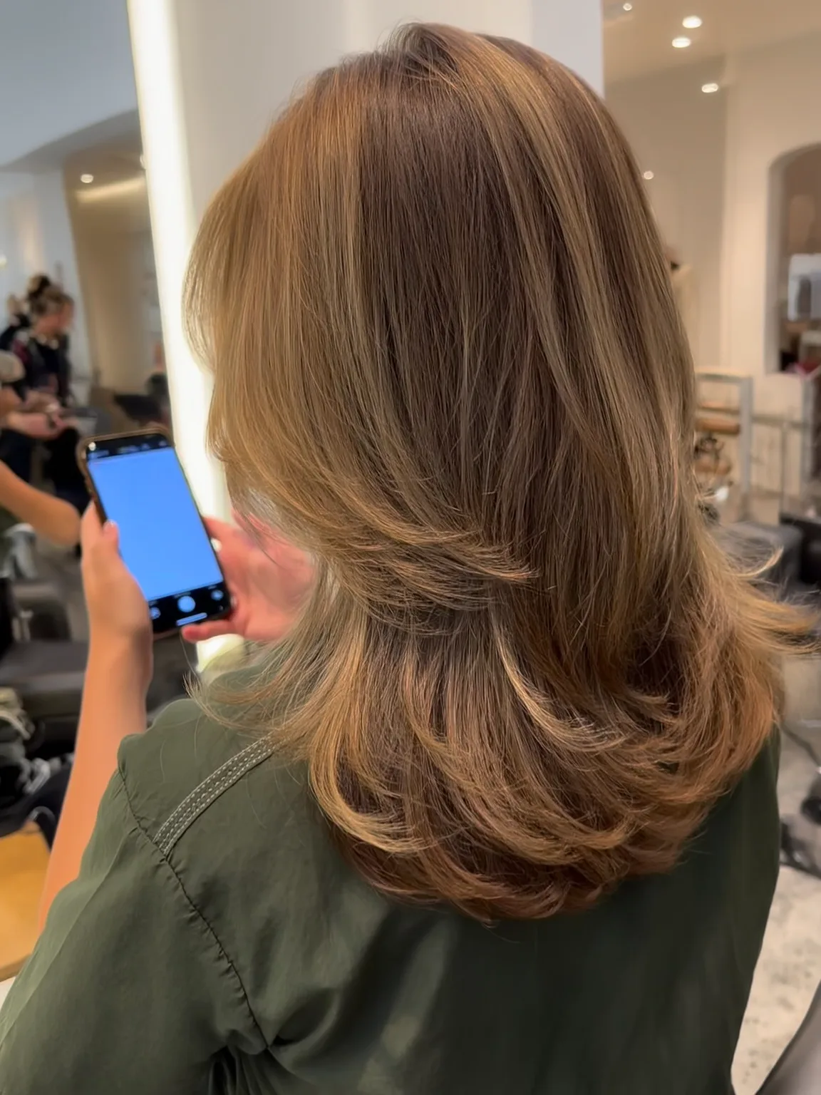 Medium-Length Feathered Layers with Long Bangs in Caramel Brown